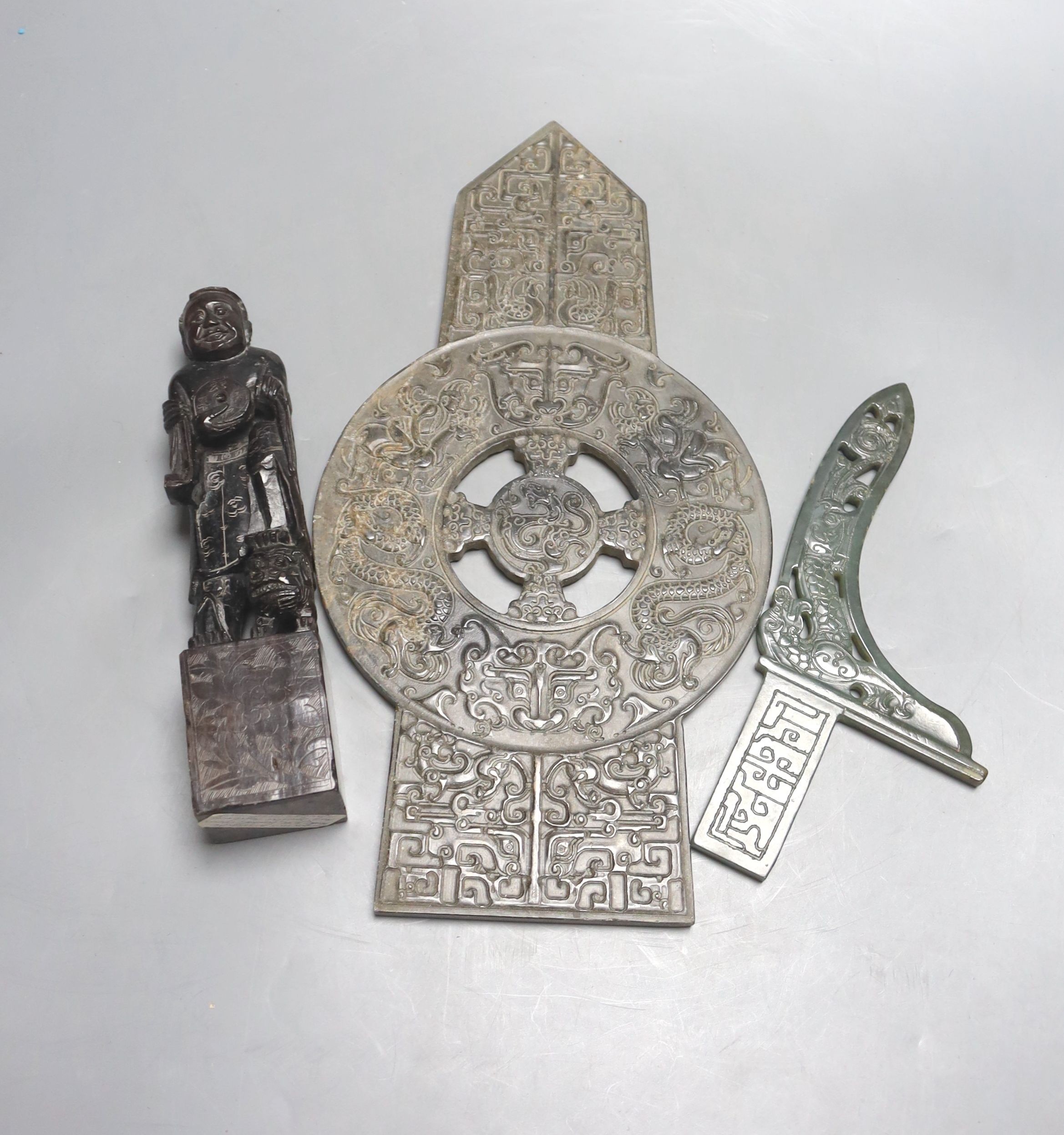 A Chinese archaistic stone plaque, a green hardstone model of an axe dagger and a soapstone 'Liu Hai' seal (3)